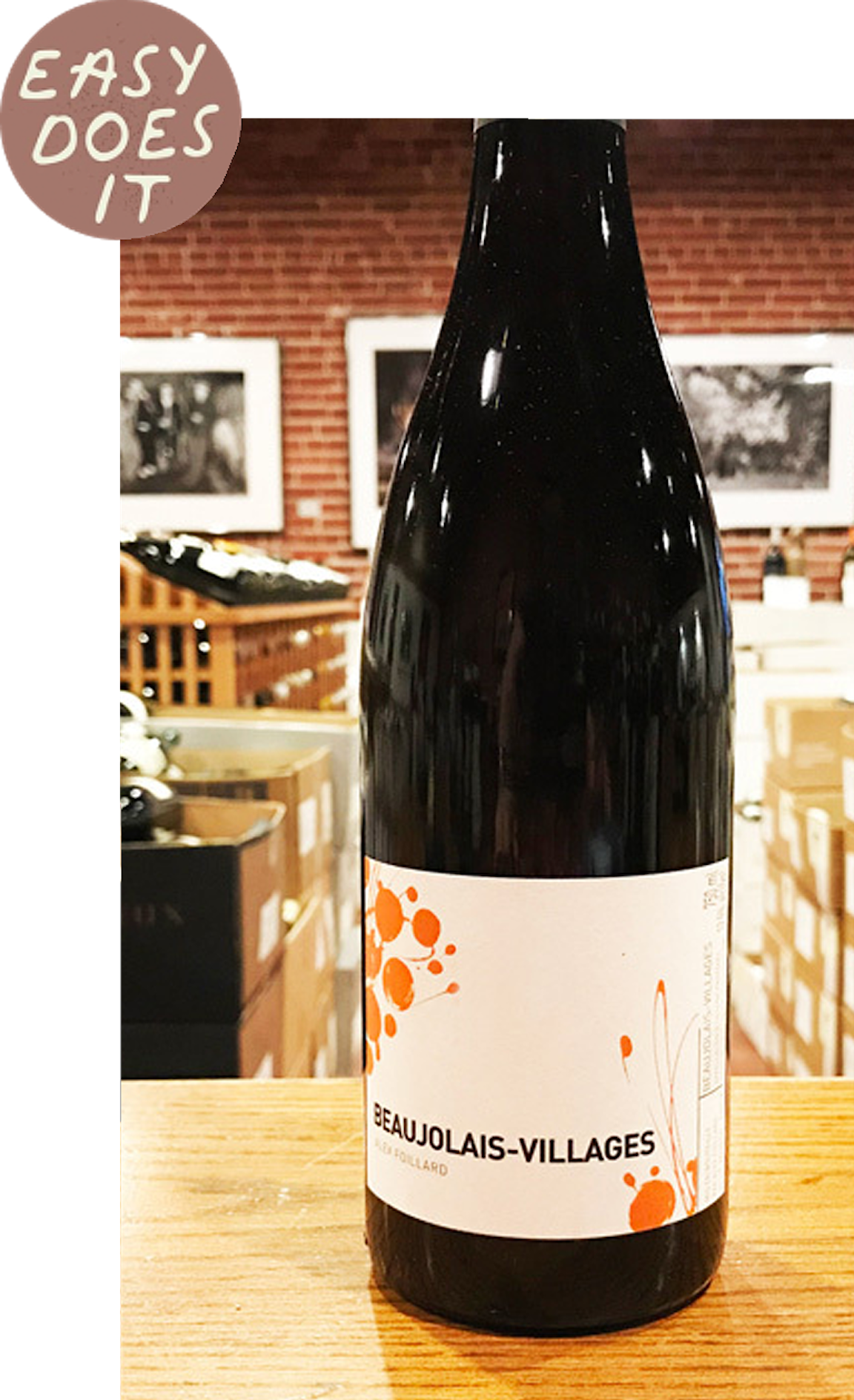 A bottle of wine with a white and orange label.